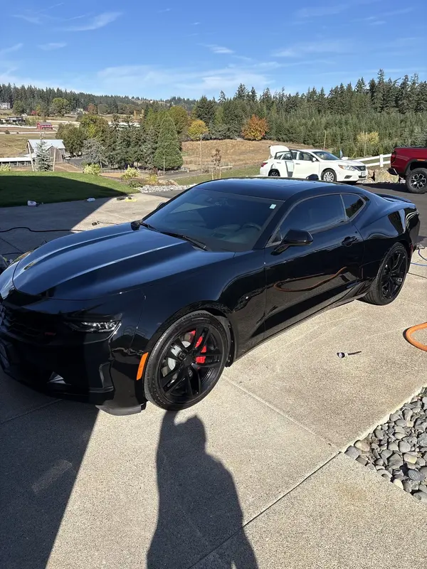 Camaro with ceramic coating shine parked in a field
